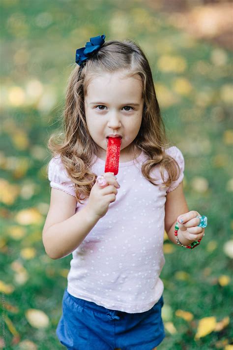 Beautiful Young Girl Eating A Popsicle Del Colaborador De Stocksy