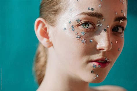 Closeup Portrait Of Pretty Girl With Silver Stars On Her Face By