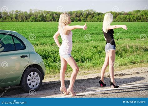 Two Blonde Girls Standing Near Their Broken Car And Hitchhiking Stock Image Image Of