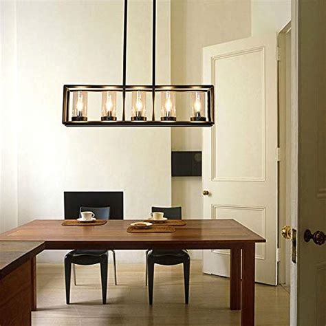 This substantial black chandelier offers an unadorned minimalist silhouette consisting of a large iron ring with four iron rods extending upward in a pyramidal shape. SUSUO Wrought Iron Black Rectangular Chandelier - 5 Lights ...