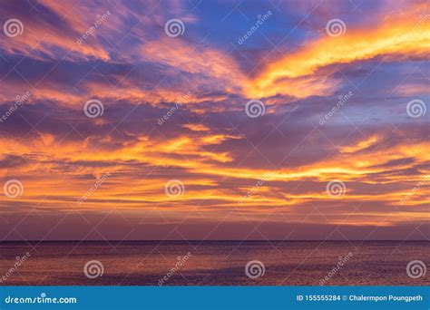Colorful Sunset Sky Over The Ocean With Dramatic Clouds Stock Photo