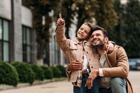 Happy Father And Son Embracing On Street In Autumn Day Stock Image
