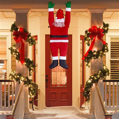 Christmas Hanging Santa Suit From On The Gutter Roof Outdoor Decoration