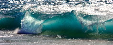 Ke Ale An Aqua Toned Wave Curls On A Beach In Hawaii Photograph By