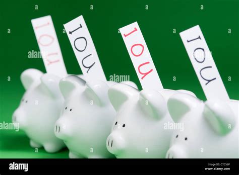 Group Of Piggy Banks With Ious Coming Out Of Coin Slots Stock Photo