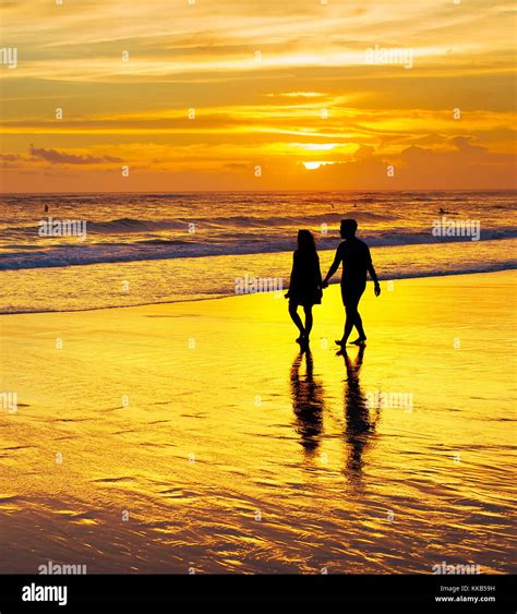 Couple Walking On A Tropical Beach At Sunset Bali Island Indonesia