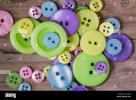 Pile Of Pastel Coloured Buttons On A Wooden Background Stock Photo Alamy