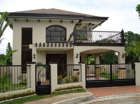 A White House With Black Gate And Balcony