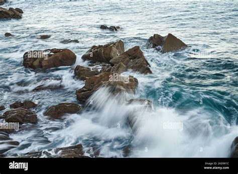 Waves Breaking On The Rocks With Long Exposure Image Stock Photo Alamy