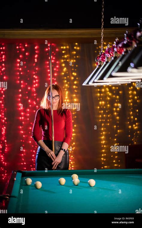 Billiard Club A Woman With In Glasses With Red Hair And Nice Figure Standing By The Table