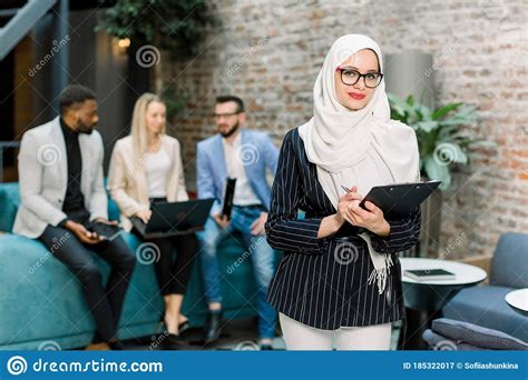 Young Pretty Muslim Business Woman In White Hijab And Eyeglasses
