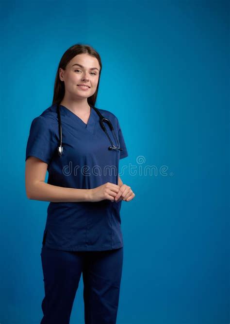 Smiling Nurse Standing And Holding Clipboard By Her Hands Turning The