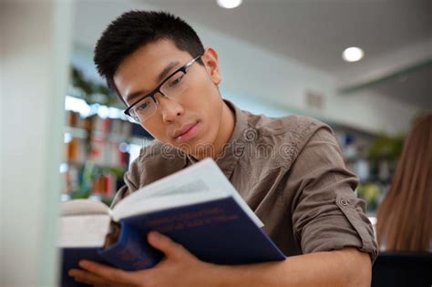 Asian Male Student Reading Book In University Stock Photo Image 61062825