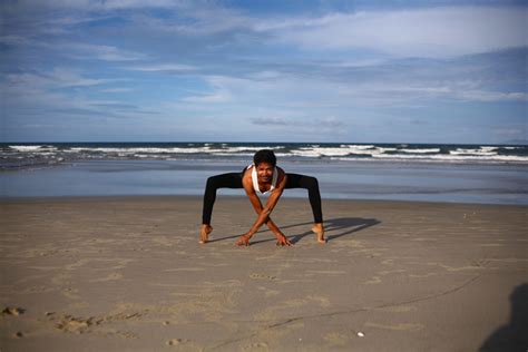 Flexible Man Practicing Yoga Bending In Variation Of Goddess Or Sumo