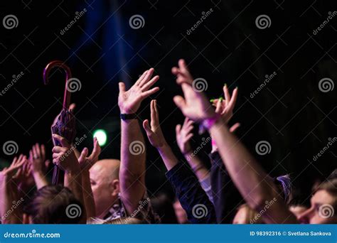 Crowd Of People With Their Hands Up During The Rock Concert On Dark