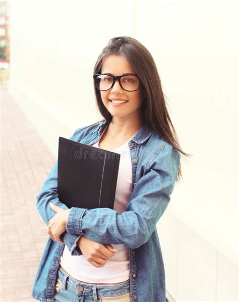 Portrait Of Smiling Student Girl In Glasses With Folder Stock Image