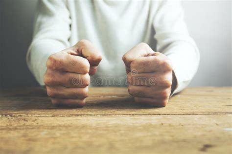 Man Fists Clenched On A Wooden Table In Anger Stock Photo Image Of