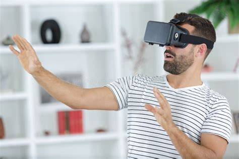 Young Man Wearing Vr Headset And Experiencing Virtual Reality Stock