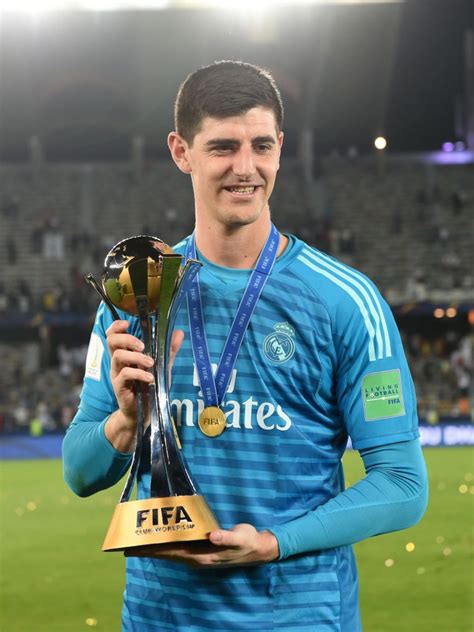Thibaut Courtois Of Real Madrid Celebrates With The Trophy After The
