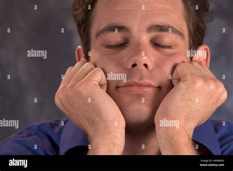 Man Resting His Chin In His Hands With Eyes Closed Stock Photo Alamy