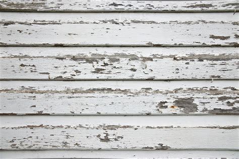 White Wood Wall With Peeling Paint Background And A Closeup Texture