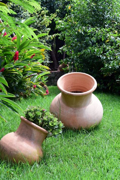 Decorative Clay Pots In The Beautiful Garden With Green Grass And