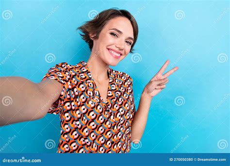 Photo Of Lovely Cheerful Person Make Selfie Toothy Smile Demonstrate V Sign Isolated On Blue