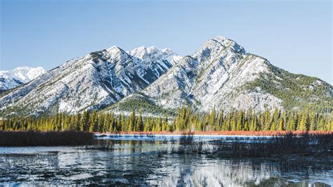 Beautiful White Covered Mountains Reflection On Lake Under Blue Sky 4k