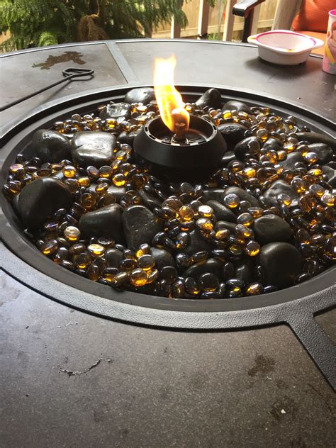 There are no designated swimming areas. A tiki torch (lamp) in the middle of a fire pit table ...