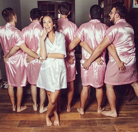 A Group Of People In Pink And White Robes Standing Around Each Other