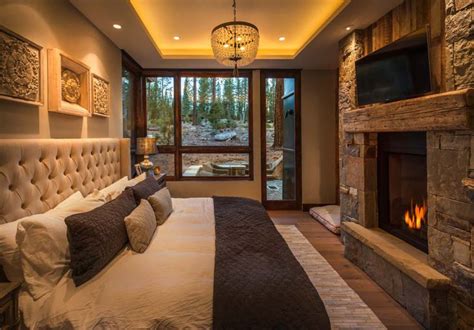 A Bedroom With A Large Bed And Fireplace