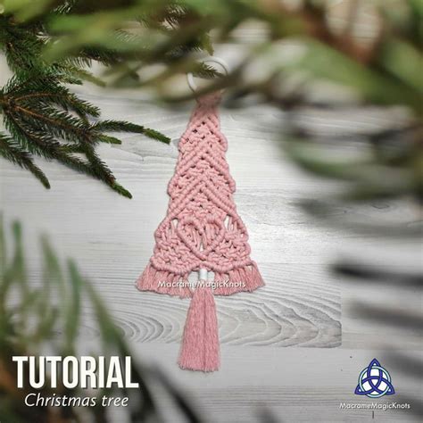 A Crocheted Christmas Tree Ornament Hanging From A Pine Branch With