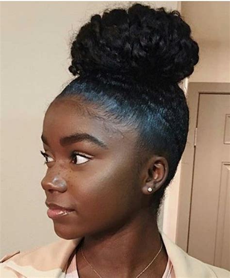 The hair is tied up to make a bun either normally or with braids depending upon the preference. 15 Ideas of Updo Hairstyles with Bangs for Black Hair