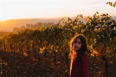 Girl Looking At Camera At Sunset In A Vineyard Of The Tuscan Region By