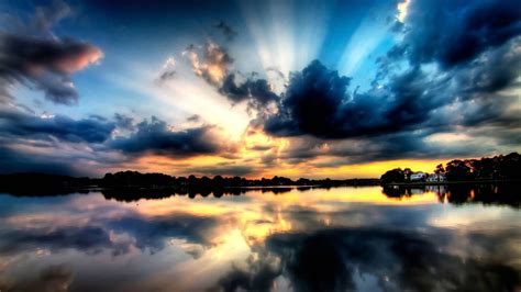 Download A Picturesque Sunset Reflected In The Still Water Wallpaper
