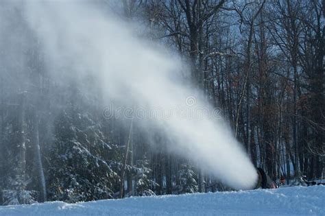 Snow Making Machine Shooting Out Artificial Snow On Ski Hill Stock