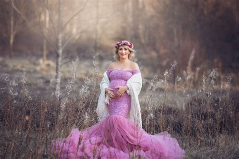 Beautiful Blond Pregnant Woman In A Stunning Pink Gown Posing For A