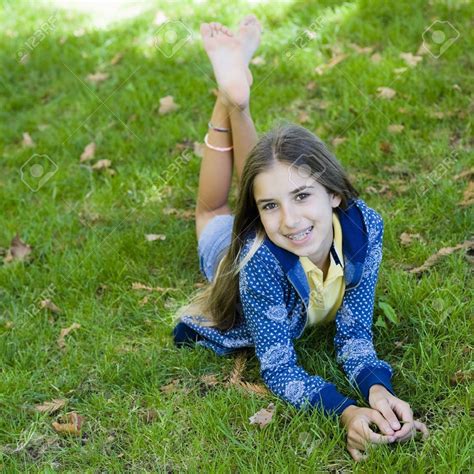 Portrait Of Smiling Tween Girl Lying On Grass Smiling To Camera Stock Photo Tween