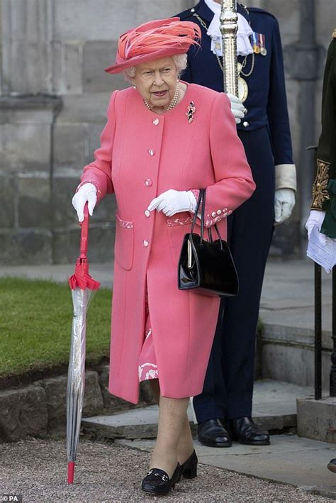 Her Majesty Brought The Sunshine In Her Bright Ensemble But Was Prepared For The Unpredictable