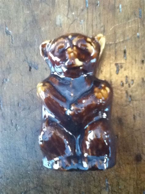 A Bear Shaped Chocolate Candy Sitting On Top Of A Wooden Table With