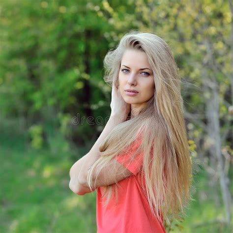 Beautiful Blonde Woman Posing And Relaxing By The Sea Stock Image