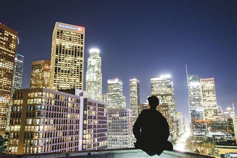 Hd Wallpaper Man Sitting On Rooftop During Nighttime City Urban
