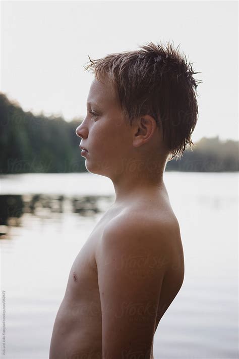 Profile Portrait Of Pre Teen Boy After Swimming In Lake In Summer By