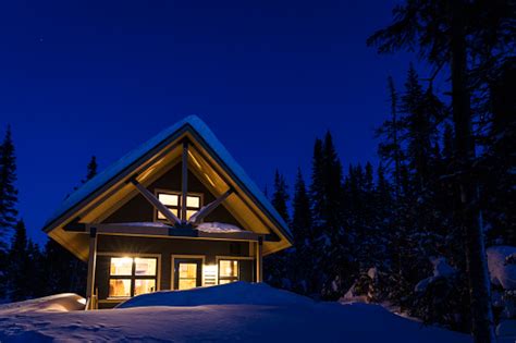 Wooden Cottage Log Home Log Cabin In Winter At Night Stock Photo