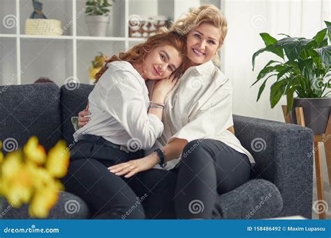 Free Photo Woman Her Mother And Her Daughter Sitting On A Couch My