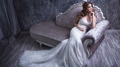 Beautiful Girl Model With White Long Gown Is Sitting On Couch Hd Model