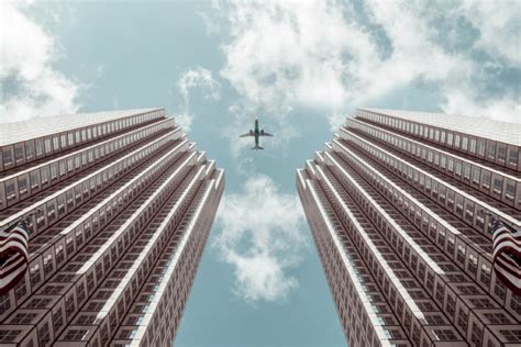 Airplane Between Buildings Free Photo Free Photo