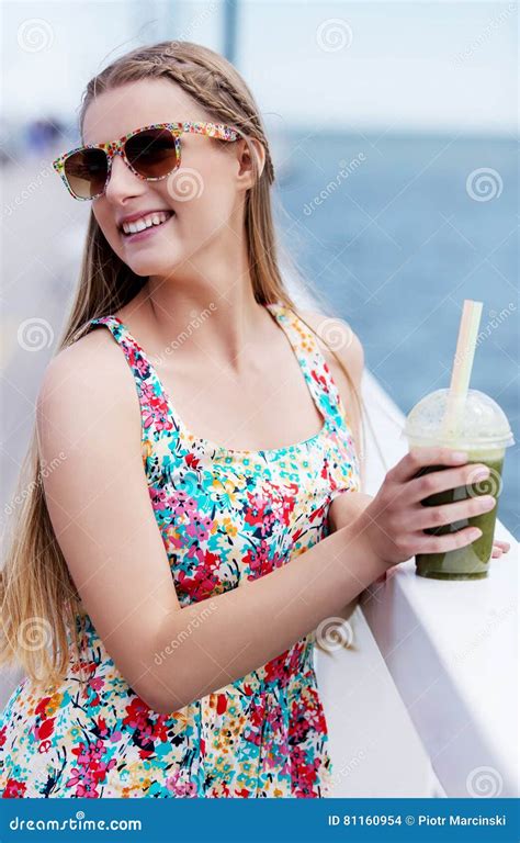 Beautiful Young Woman With Sunglasses Drinking Green Vegetable Smoothie