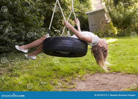 Young Girl Playing On Tire Swing In Garden Stock Photo Image Of
