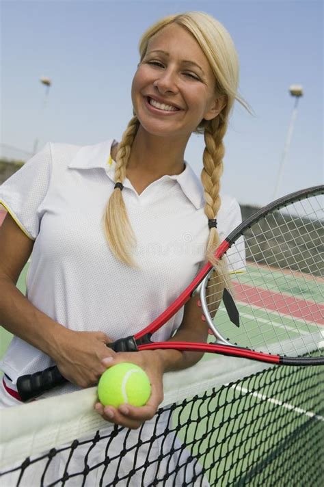 Female Tennis Player At Net On Tennis Court Portrait Stock Image